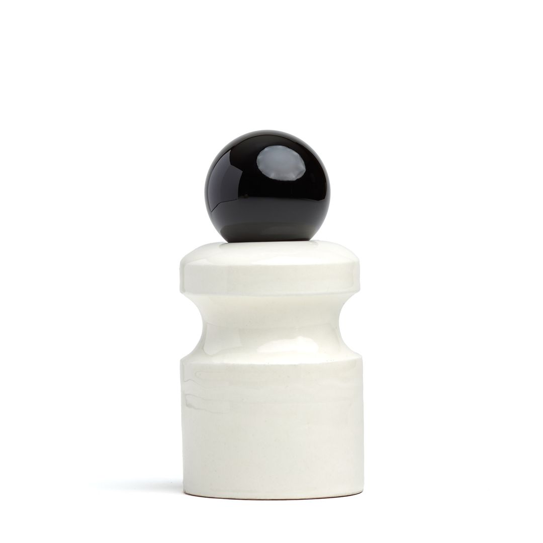 Caledonian Pear ceramic vessel on white, a pale glazed form holding a glass orb.