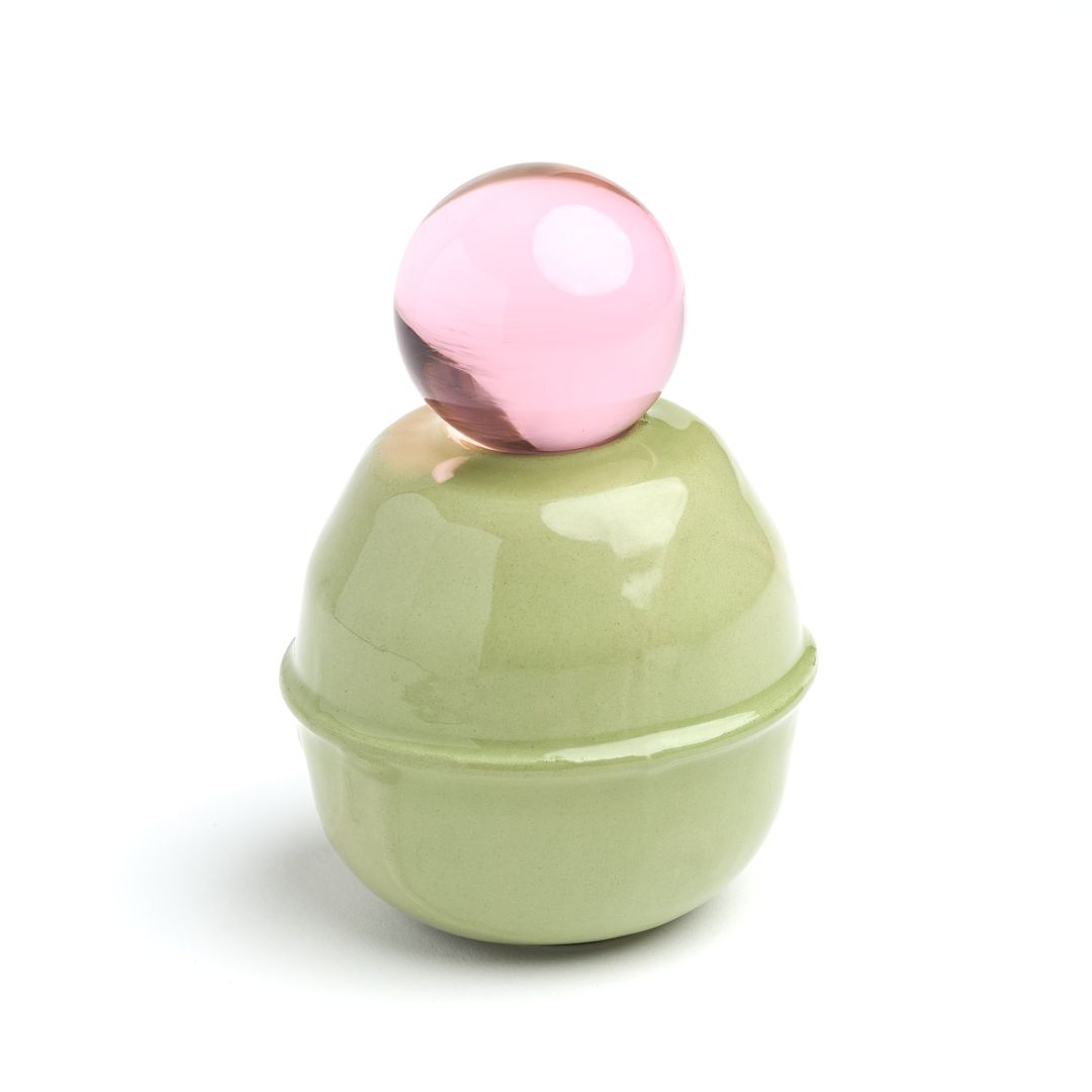 Rose Interval ceramic vessel seen from above, the glass orb resting on the pale green glaze.
